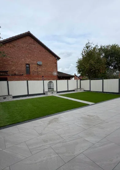 Narrow garden path with artificial grass and patio