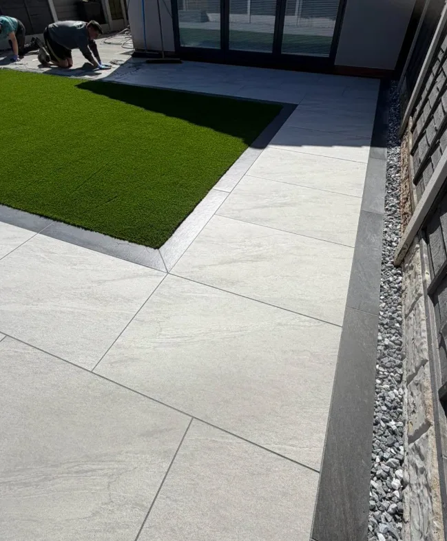 Porcelain patio with artificial grass border, Wigan
