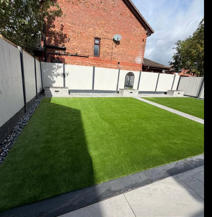 Modern garden patio with bi-fold doors and artificial grass