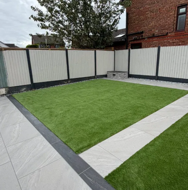 Stone-effect patio with retaining wall and steps
