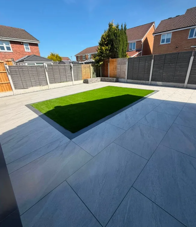 Square artificial grass lawn set into porcelain patio